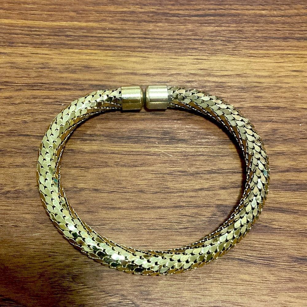 Bangle Bracelet in Polished Gold Tone with Woven Texture.
